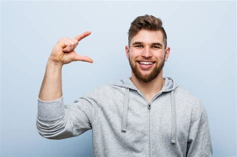 Premium Photo Young Handsome Fitness Man Holding Something Little