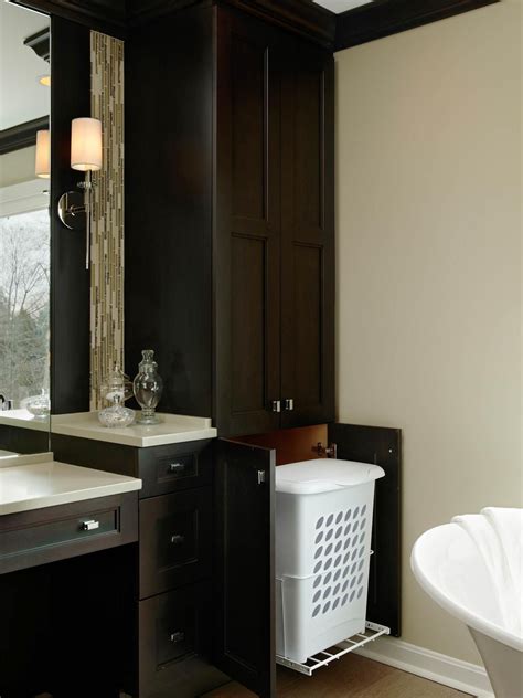 A Transitional Master Bathroom Features Custom Cabinetry With A Hamper