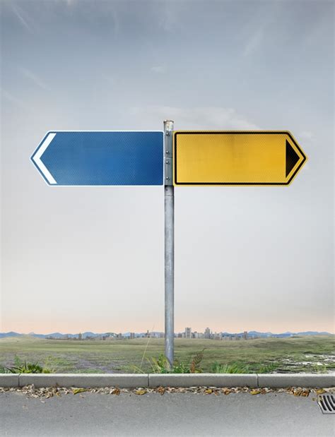 Blank Yellow And Blue Road Signs Pointing In Opposite Directions Stock