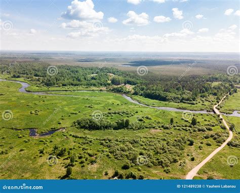 Beautiful Aerial View Of Meandering River With Bright Green Mead Stock