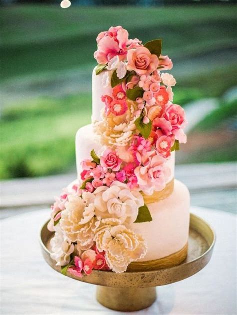 three tier blush wedding cake with cascading flowers get inspired by these beautiful cascading