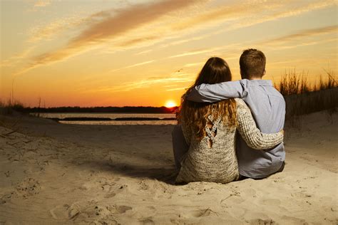 Engaged Couple Watch Sunset At Beach During Engagement Shoot Beach