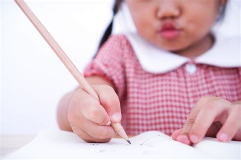 Premium Photo Close Up Little Child Learning To Write On Paper