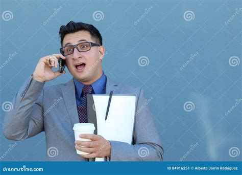 Embarrassed Looking Businessman Listening To Someone On Cellphone