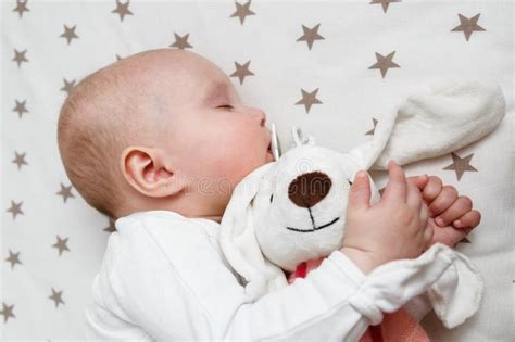 Baby Is Sleeping In The Bed With Rabbit Toy Stock Photo Image Of Baby