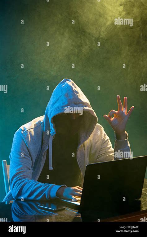 Hooded Computer Hacker Stealing Information With Laptop Stock Photo Alamy