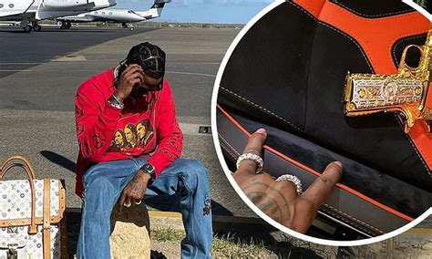 Travis Scott Travels With Protection As He Flashes A Gold Gun Before