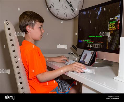 Two Young Boys Play Video Games At Long Distance Communicating Via