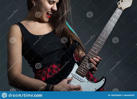 Portrait Of A Beautiful Brunette Screaming Playing A Riff On An