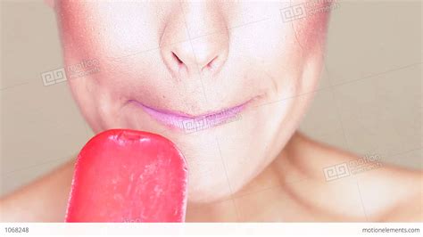 Woman Licking An Icecream Lolly Stock Video Footage 1068248