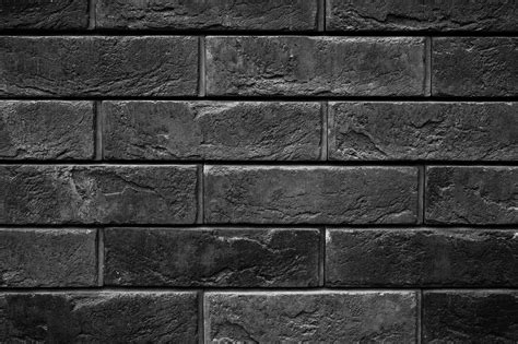 Pattern Of Tinted Black Stone Wall Surface As A Background 600930