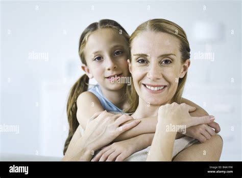 Mother And Daughter Embracing Both Smiling At Camera Stock Photo Alamy