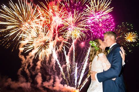 couple kissing underneath fireworks