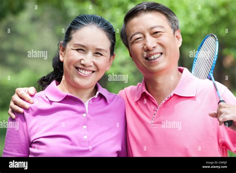 Happy Couple Playing Badminton In Park Stock Photo Alamy