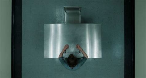 A Person Standing In Front Of A Urinal With Their Hands On The Ground