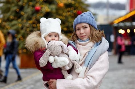 Mother And Daughter Are Walking Around The City On Christmas And New