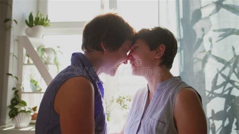 Two Young Women Hug And Kiss At Home Casual Clothing Lesbian Couple Homosexual Relations