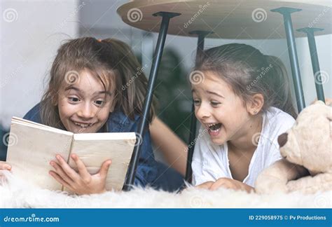Children Have Fun Reading A Book Together Stock Image Image Of