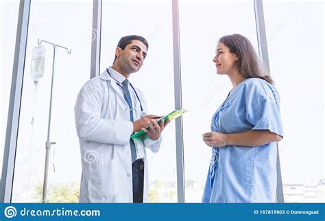 Doctor Consulting And Examining Patient Woman For Her Health Stock