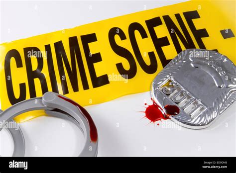 Crime Scene Tape With Blood Covered Police Badge And Handcuffs Stock
