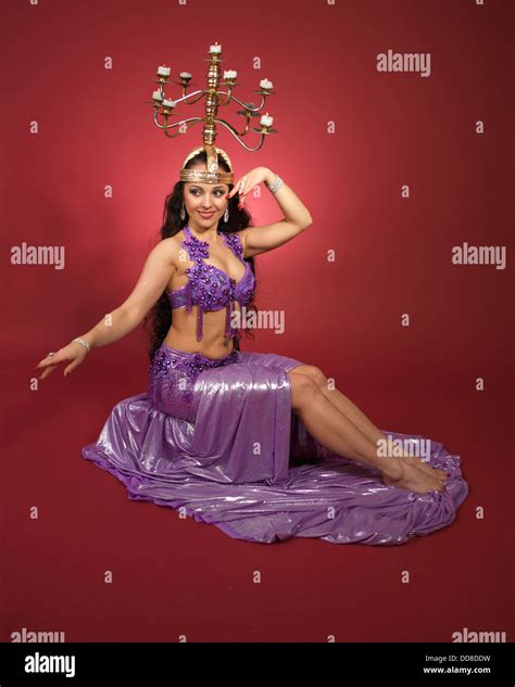 Beautiful Professional Bellydancer Wearing Costume In Front Of The Red Backdrop Stock Photo Alamy