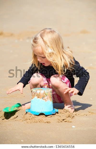 Cute Little Girl Playing Sand On Stock Photo Edit Now 1365616556