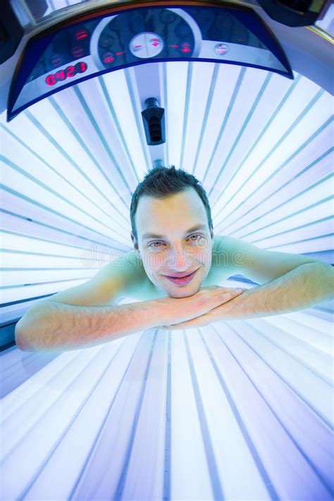Handsome Young Man Relaxing During A Tanning Session Stock Image