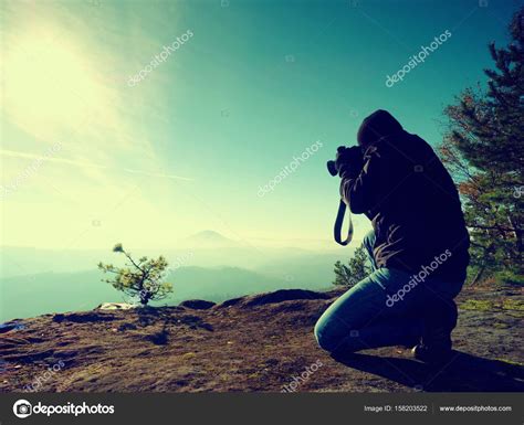 Photographer Look Down Into Fogy Valley Man Is Kneeling On Cliff And