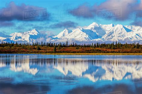 Scenic View Of Mcginnis Peak And The Alaska Range Reflecting In