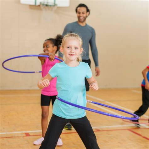 Kids Exercising In Gym Class With Hula Hoops Spiderfit Kids