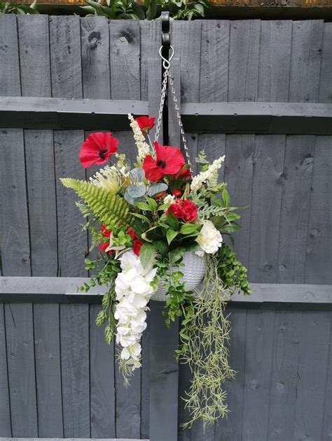 A broad selection of bulk flowers. Red and white artificial faux outdoor hanging basket. Faux ...
