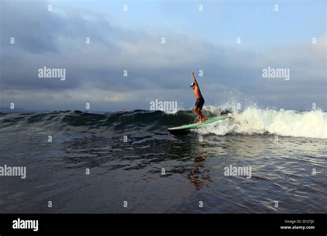Longboard Surfer Surfing A Wave In Batu Karas On The South Coast Of