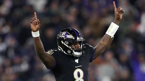 Lamar Jackson Is Wearing Black Sports Dress And Helmet With Hands In