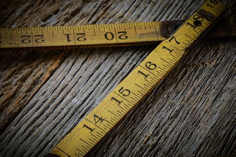 Old Tape Measure On Rustic Wood Background Photograph By Brandon