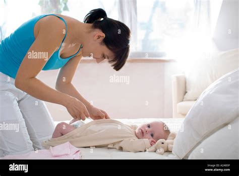 Mother Changing Diaper Stock Photo Alamy