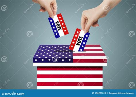 Hand Holding And Putting Voting Paper In Ballot Voting Box With Usa