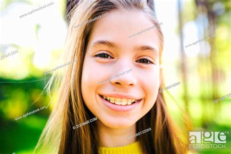 Portrait Of Modern Happy Teen Girl With Dental Braces Dressed In Yellow