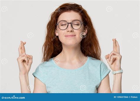 Superstitious Redhead Woman Crossing Fingers Wishing For Good Luck