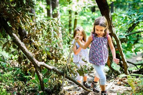 Children Twin Girls Are Hiking In The Mountains Stock Photo Image