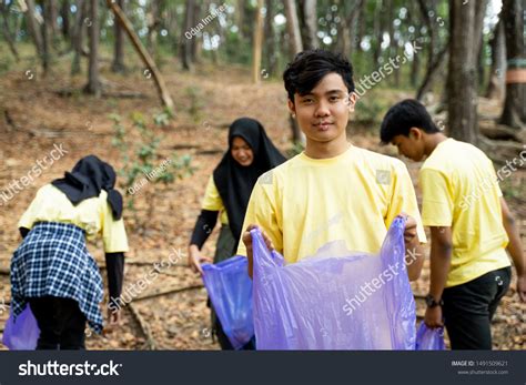 Male Smiling Volunteer Holding Trash Bag Stock Photo 1491509621