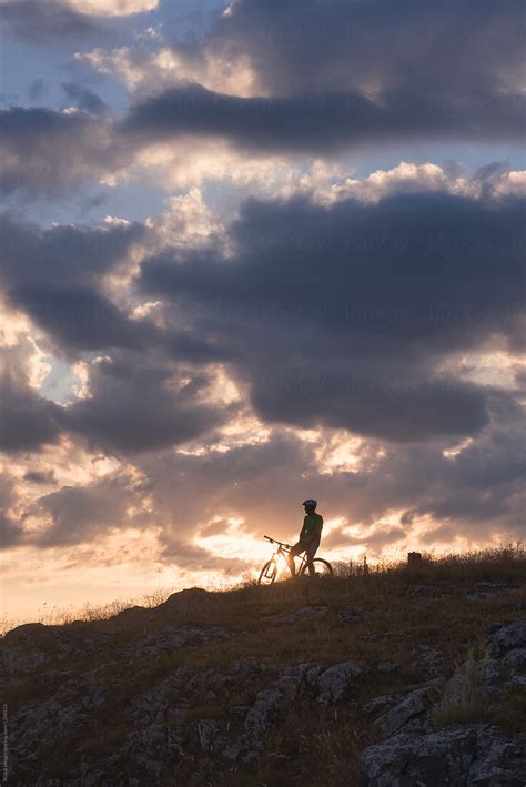 Male Cyclist Silhouette Standing On A Hill During Twilight Del Colaborador De Stocksy Ibex