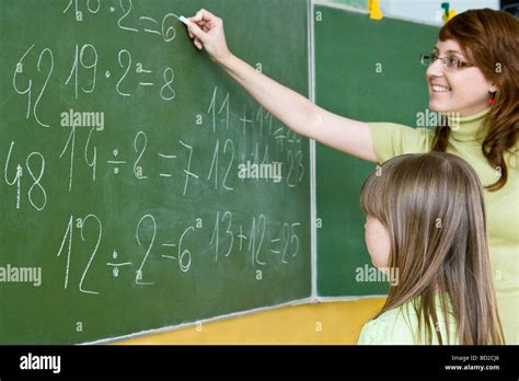 Teacher Writing On Blackboard Stock Photo Alamy