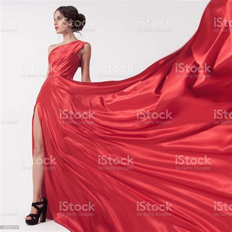 Young Beauty Woman In Fluttering Red Dress White Background Stock Photo