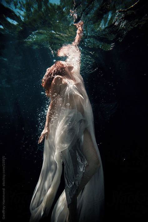 Woman Underwater Reaching To The Surface By Stocksy Contributor