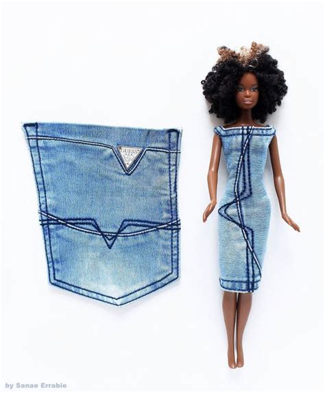 A Doll In A Dress Next To A Denim Pocket With A Barbie Doll Inside It