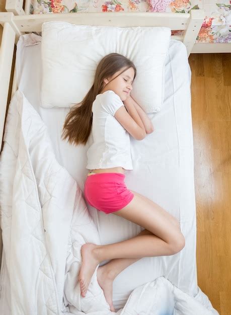 Premium Photo View From Above On Brunette Teenage Girls In Pink Pajamas Sleeping On Bed