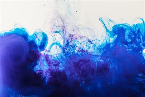 Artistic Background With Blue And Purple Paint Mixing In Water Stock