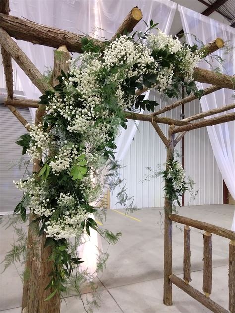 Wedding Ceremony Arch Decorated With Babies Breath And Greenery