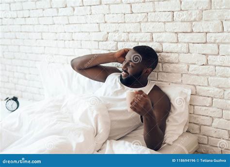 Black Awakened Man Drinks Coffee In Bed Stock Photo Image Of