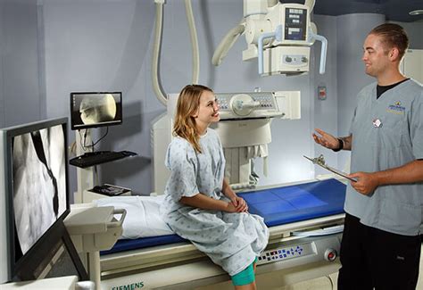 patient smiles at medical imaging technologist